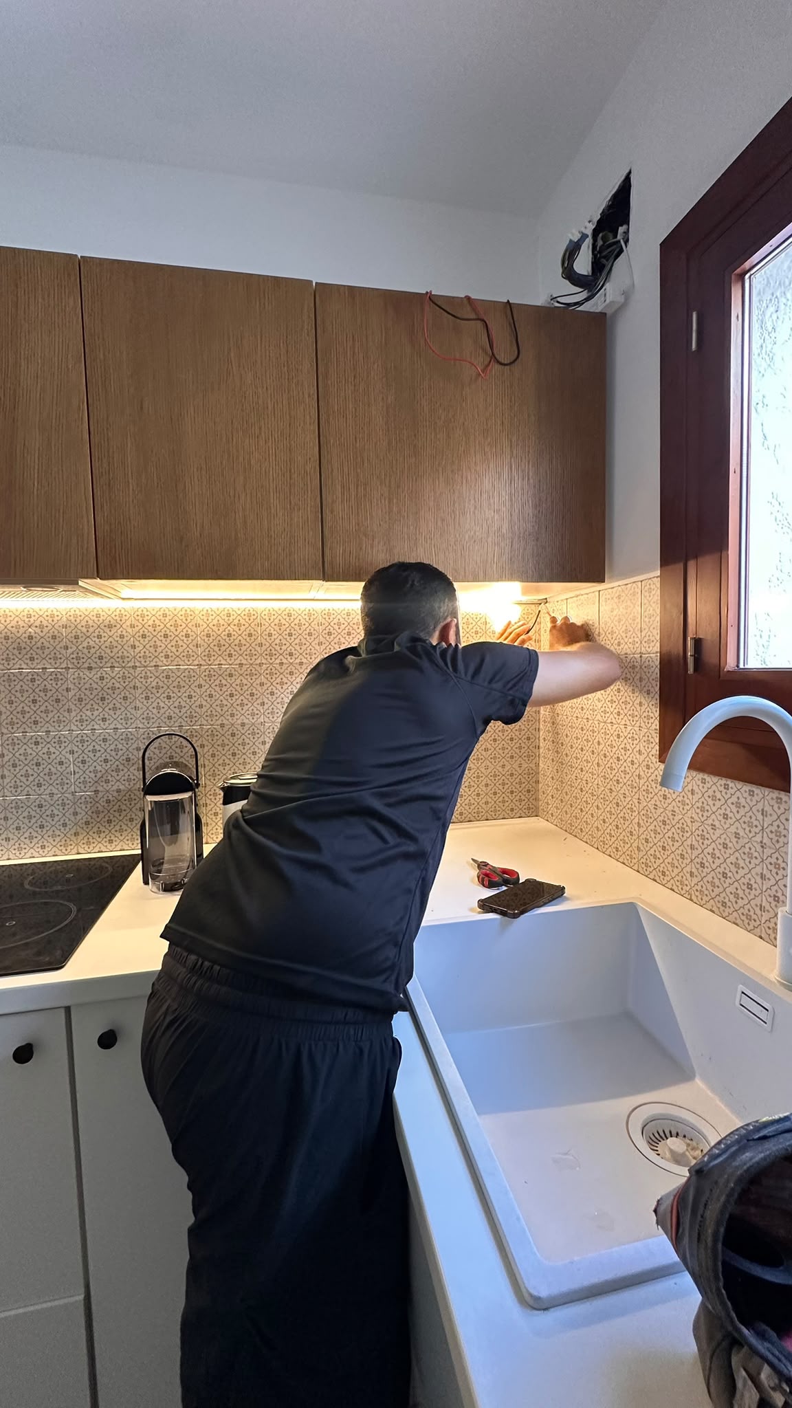 Under-cabinet LED lighting installation in a kitchen